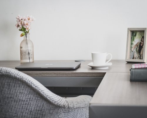 Person doing light stretching at their home office desk